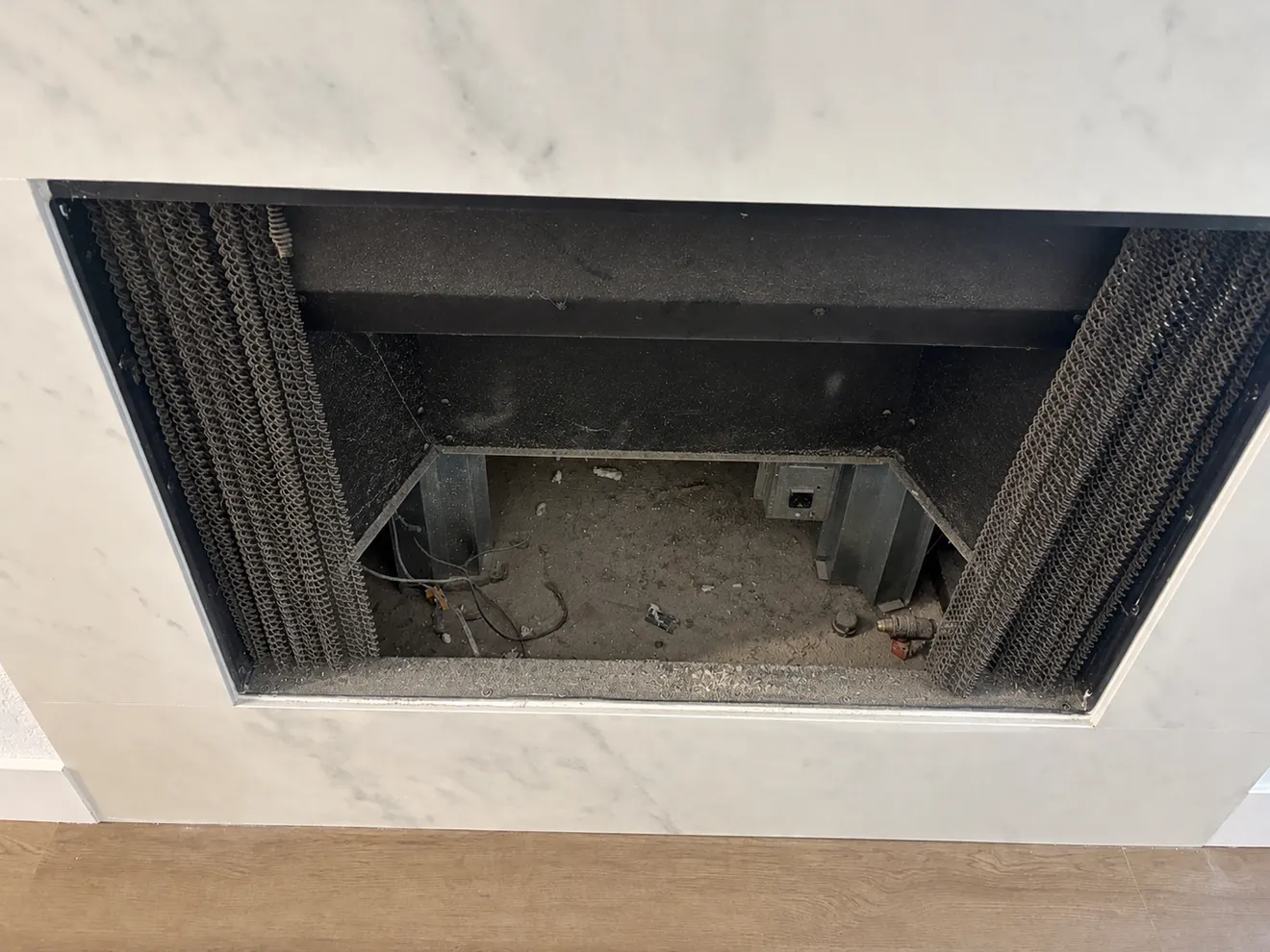 Dusty fireplace opening before debris removal